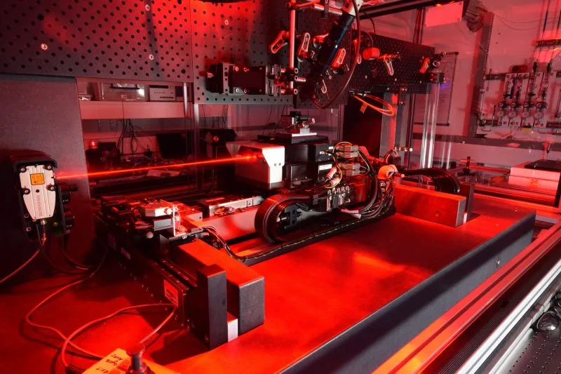 Instrumentation emitting a red laser, representing Lasers & Scientific Instrumentation.